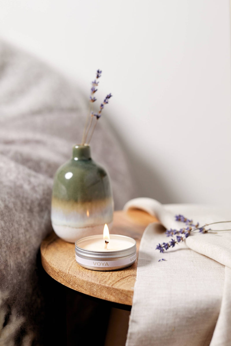 VOYA Skincare USA Lavender, Rose and Camomile Mini Scented Travel Candle by bedside